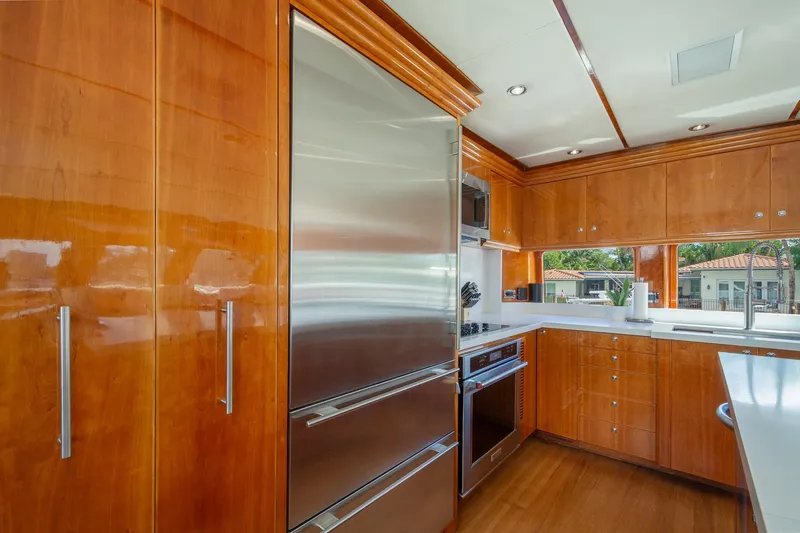 Slide: The Image of Luxurious kitchen in 2006 Hargrave Raised Pilothouse yacht with wood cabinetry and stainless steel appliances. - 29