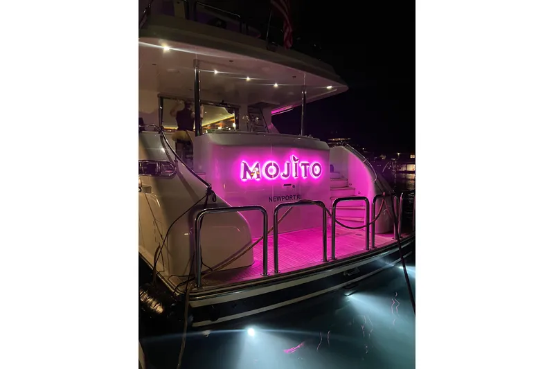 Slide: The Image of Luxury 2006 Hargrave Raised Pilothouse yacht with vibrant pink "Mojito" sign at night. - 9