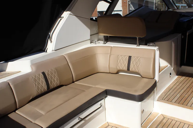 Slide: The Image of Luxurious seating area on 2017 Sea Ray Sundancer 350 Coupe yacht with beige upholstery. - 16