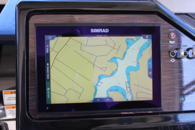 Slide: The Image of Simrad navigation display on 2017 Sea Ray Sundancer 350 Coupe boat dashboard. - 24