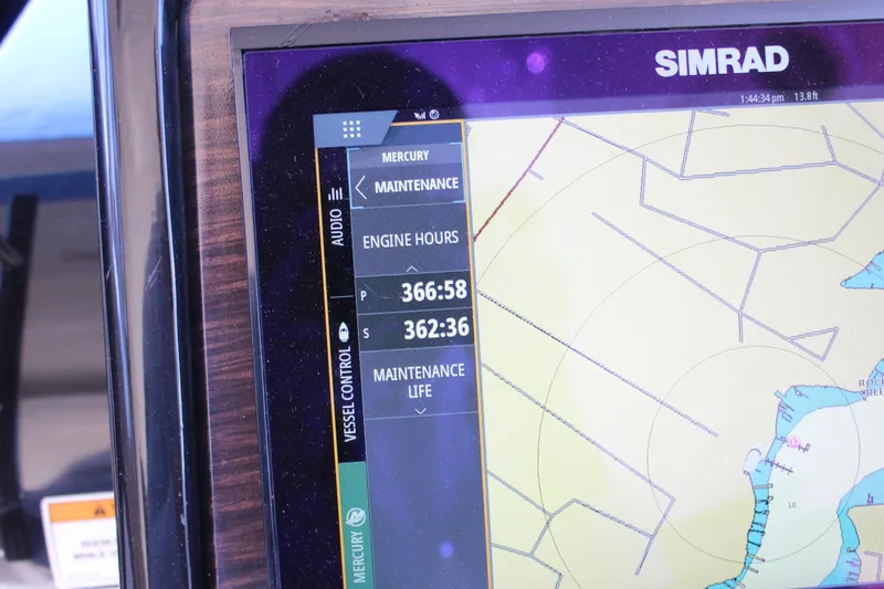 Slide: The Image of Simrad display on 2017 Sea Ray Sundancer 350 Coupe showing engine hours and navigation map. - 26
