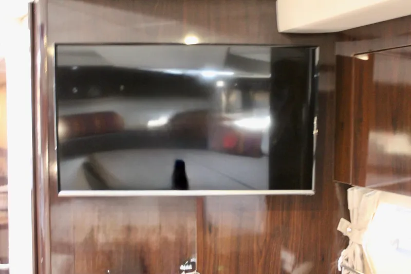 Slide: The Image of Flat-screen TV inside 2017 Sea Ray Sundancer 350 Coupe yacht interior. - 35