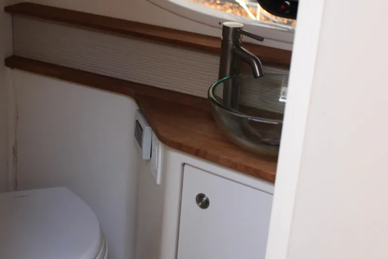 Slide: The Image of 2017 Sea Ray Sundancer 350 Coupe bathroom with modern sink and toilet. - 38