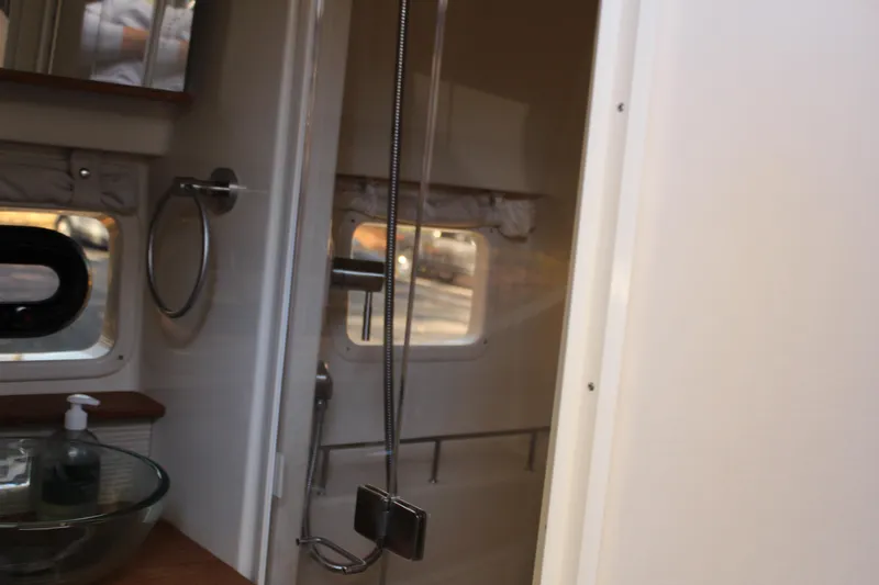 Slide: The Image of Interior of 2017 Sea Ray Sundancer 350 Coupe bathroom with glass sink and shower. - 39