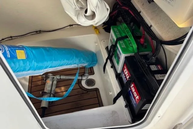 Slide: The Image of Storage compartment of 2021 Tidewater 198 CC Adventure boat with batteries and equipment. - 11