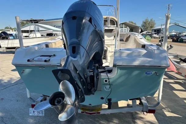 Slide: The Image of 2021 Tidewater 198 CC Adventure boat with outboard motor, parked on a trailer. - 4