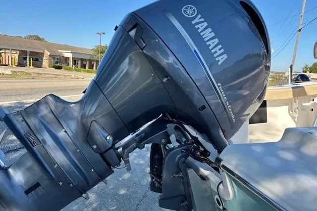 Slide: The Image of 2021 Tidewater 198 CC Adventure boat with Yamaha outboard motor, parked outdoors. - 5