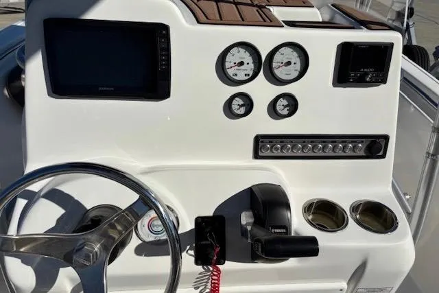 Slide: The Image of 2021 Tidewater 198 CC Adventure boat dashboard with steering wheel, gauges, and controls. - 7