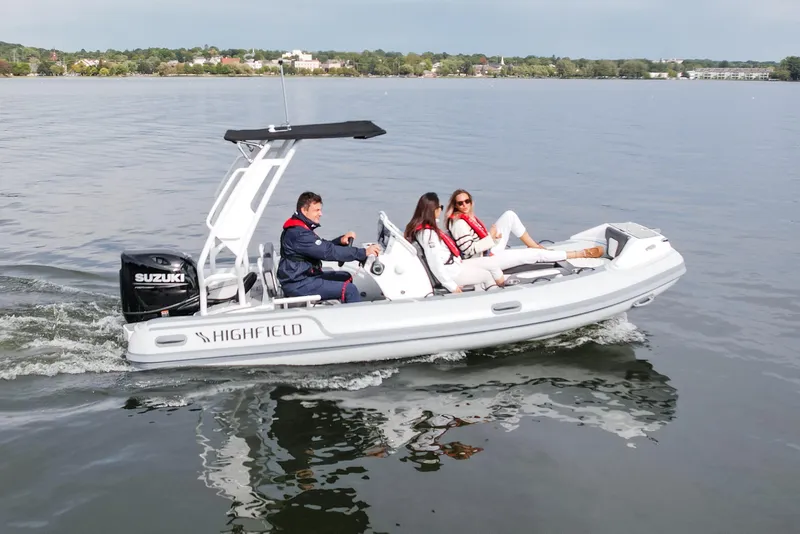 Slide: The Image of Highfield Sport 520 - 2026 Refresh boat displayed at an indoor exhibition. - 2