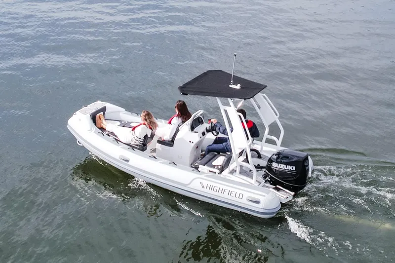 Slide: The Image of Highfield Sport 520 - 2026 model displayed at a boat show on a trailer. - 5