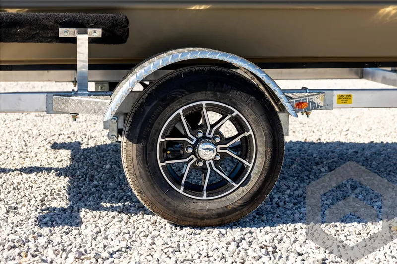 Slide: The Image of Trailer wheel of 2026 G3 1652 VBW on gravel surface, featuring black alloy rim. - 15