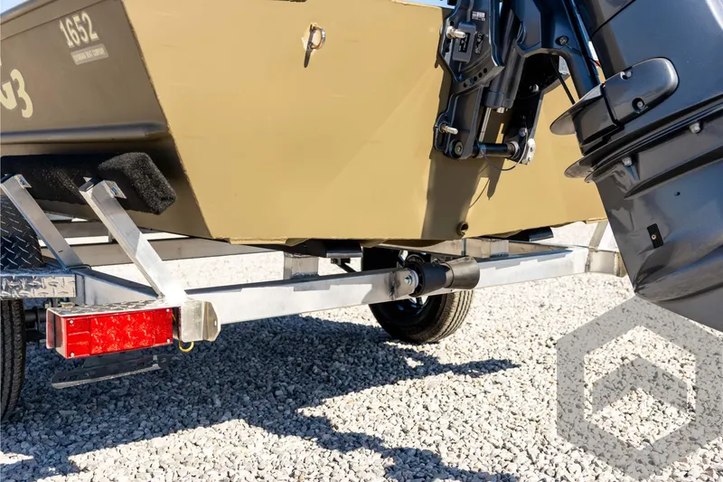 Slide: The Image of 2026 G3 1652 VBW boat on trailer, showing motor and hull details. - 21