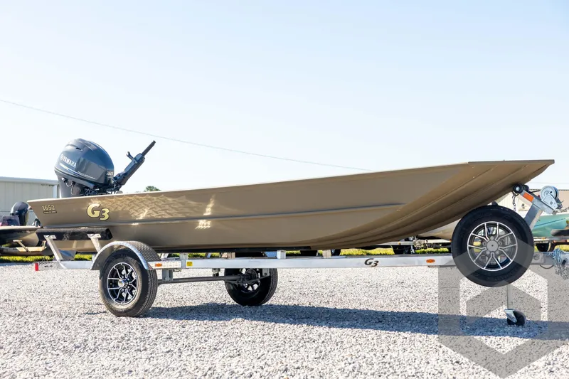 Slide: The Image of 2026 G3 1652 VBW boat on trailer with Yamaha motor, parked on gravel. - 3