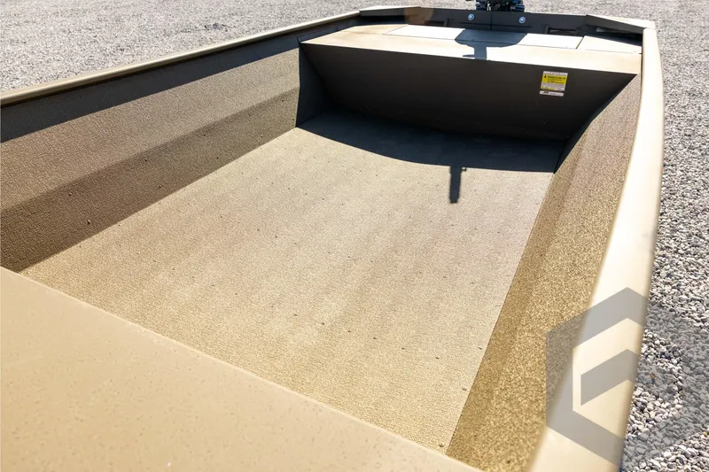 Slide: The Image of 2026 G3 1652 VBW boat interior with textured flooring, shown on gravel surface. - 36
