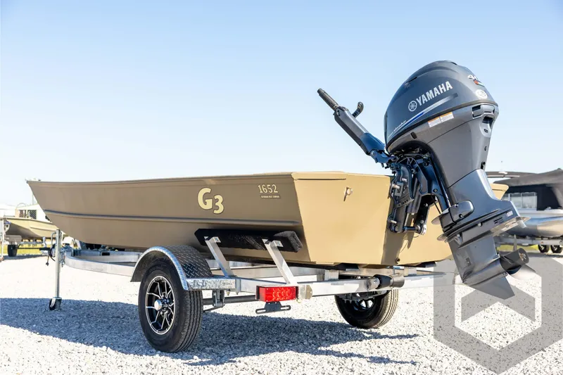 Slide: The Image of 2026 G3 1652 VBW boat with Yamaha motor on trailer, parked on gravel. - 7