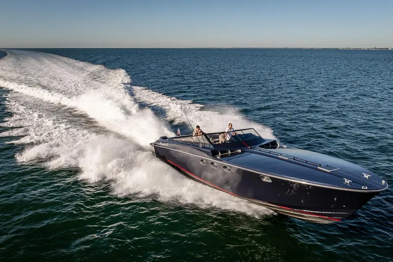 Slide: The Image of Magnum 50 Bestia 2000 speedboat cruising on open water, creating a dynamic wake. - 11