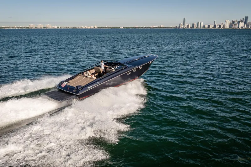 Slide: The Image of Speedboat Magnum 50 Bestia 2000 cruising on open water near city skyline. - 17