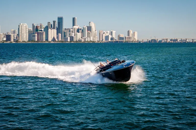Slide: The Image of Magnum 50 Bestia boat cruising near city skyline, 2000 model. - 18