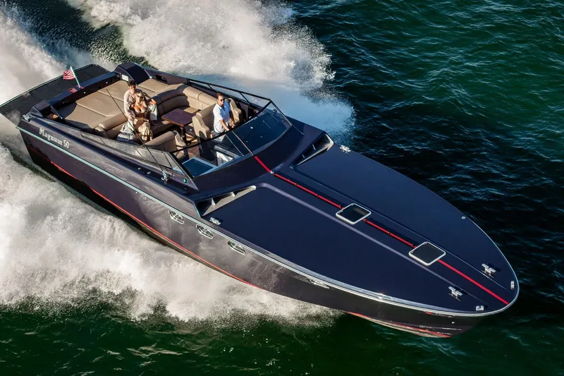Slide: The Image of Luxury Magnum 50 Bestia yacht cruising on water, 2000 model, with passengers enjoying the ride. - 23