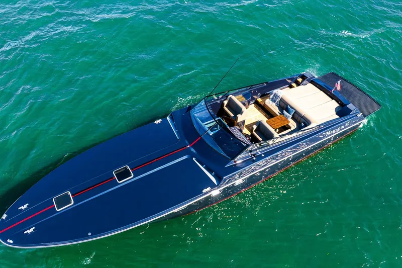 Slide: The Image of Aerial view of 2000 Magnum 50 Bestia yacht cruising on turquoise waters. - 24