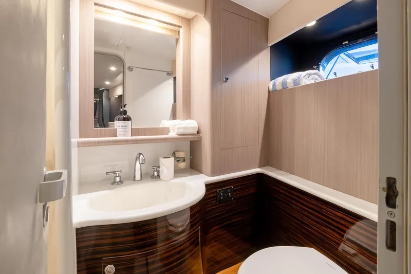 Slide: The Image of Luxurious bathroom interior of 2000 Magnum 50 Bestia yacht with modern fixtures and wood accents. - 25