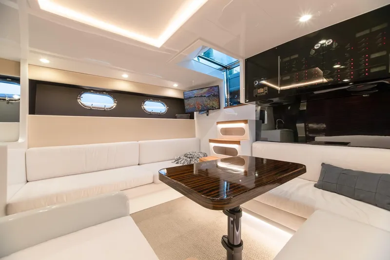 Slide: The Image of Luxurious interior of 2000 Magnum 50 Bestia yacht with modern seating and elegant table. - 27