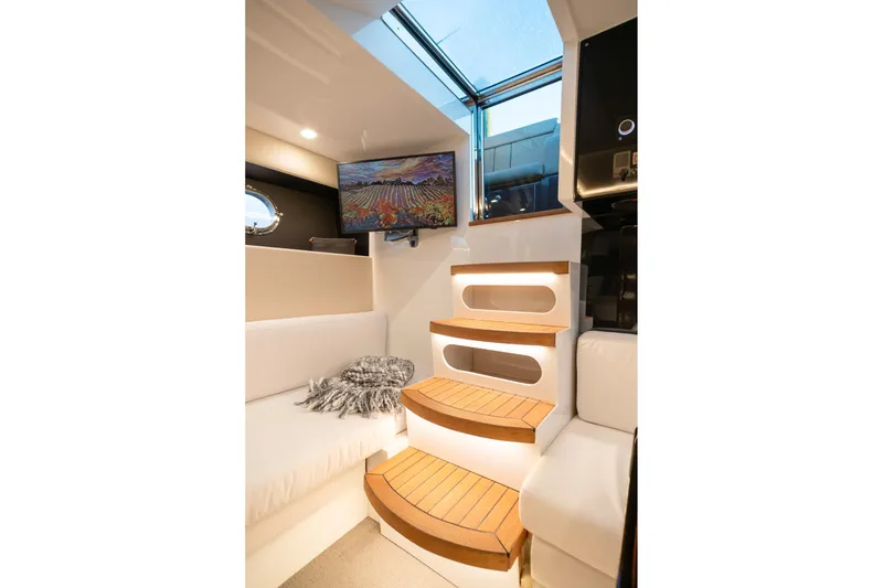 Slide: The Image of Luxurious interior of 2000 Magnum 50 Bestia yacht with modern seating and wooden steps. - 28
