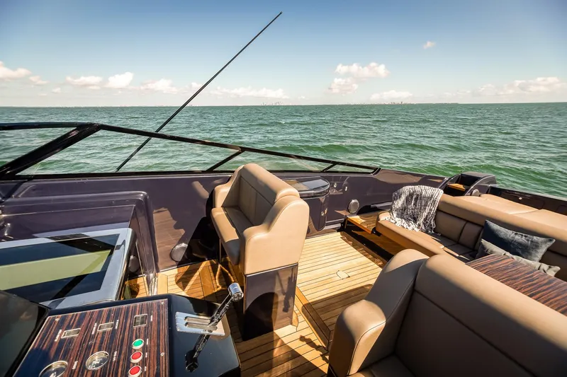 Slide: The Image of Luxurious Magnum 50 Bestia yacht interior with ocean view, featuring plush seating and modern controls. - 35