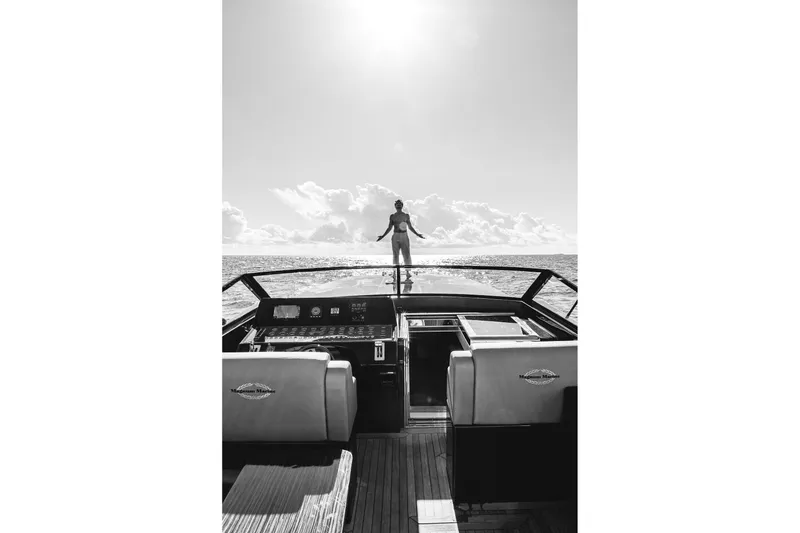 Slide: The Image of Black and white photo of a Magnum 50 Bestia yacht, 2000 model, with person on deck. - 46