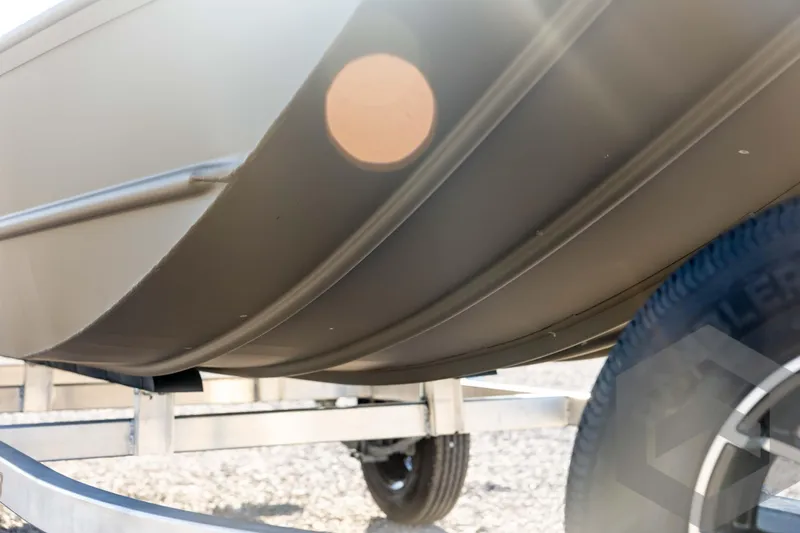 Slide: The Image of 2026 G3 1652 VBW boat on trailer, close-up view of hull and tire. - 12