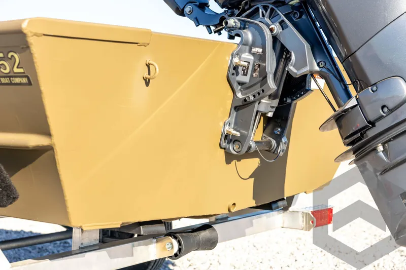 Slide: The Image of 2026 G3 1652 VBW boat with motor mount detail, beige hull, and trailer. - 24