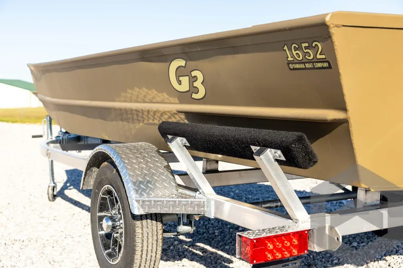 Slide: The Image of 2026 G3 1652 VBW boat on trailer, side view, outdoors. - 25