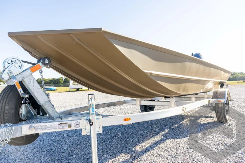 Slide: The Image of 2026 G3 1652 VBW boat on trailer, parked on gravel lot under clear sky. - 26