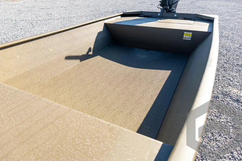 Slide: The Image of 2026 G3 1652 VBW boat interior with motor, on gravel surface. - 38