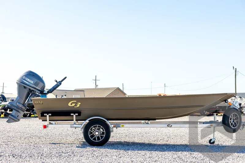 Slide: The Image of 2026 G3 1652 VBW boat with Yamaha motor on trailer, parked on gravel. - 4