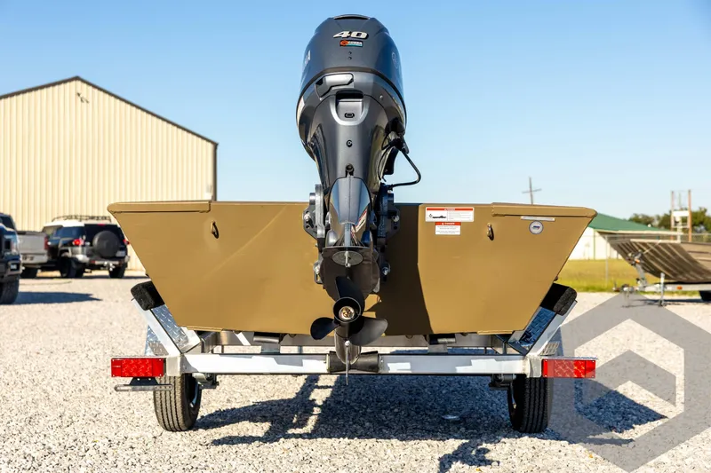 Slide: The Image of 2026 G3 1652 VBW boat on trailer with outboard motor, parked on gravel. - 6