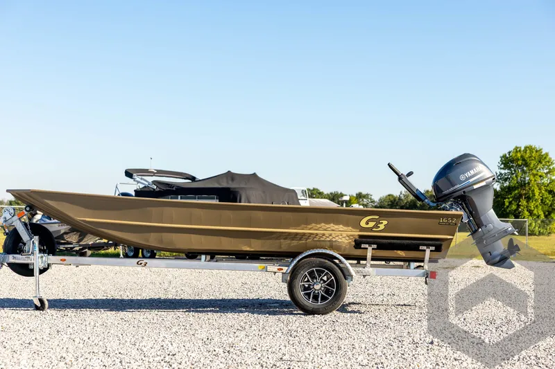 Slide: The Image of 2026 G3 1652 VBW boat on trailer with Yamaha motor, outdoor setting. - 8
