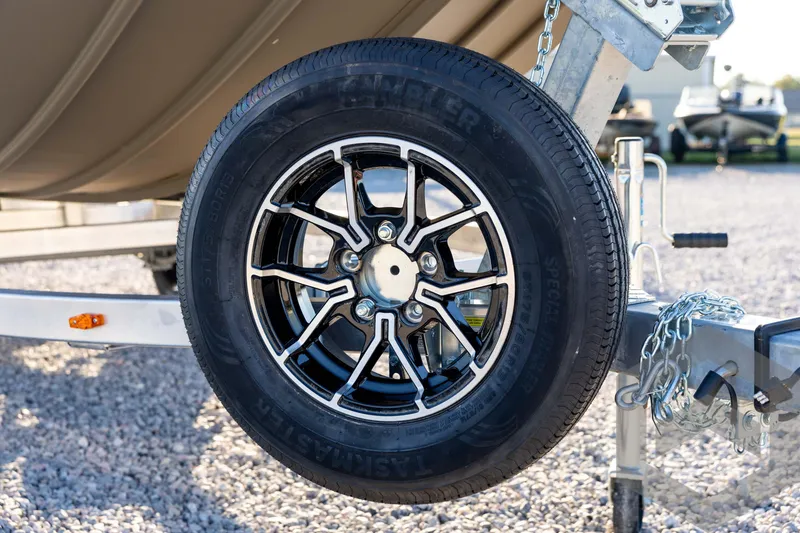 Slide: The Image of Trailer wheel of 2026 G3 1652 VBW boat on gravel surface. - 10