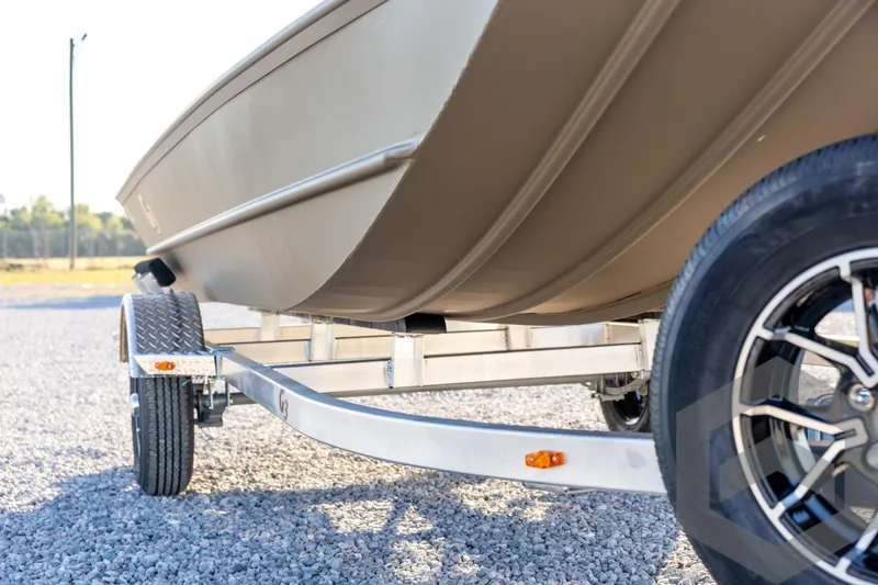 Slide: The Image of 2026 G3 1652 VBW boat on trailer, close-up view of hull and wheel. - 12