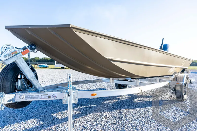 Slide: The Image of 2026 G3 1652 VBW boat on trailer, parked on gravel, under clear sky. - 27