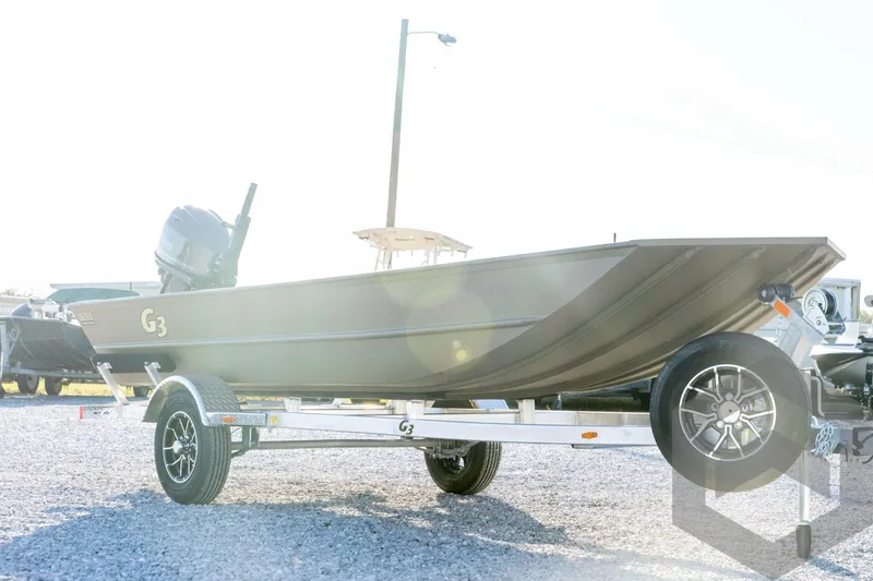 Slide: The Image of 2026 G3 1652 VBW boat on trailer, parked on gravel lot. - 3