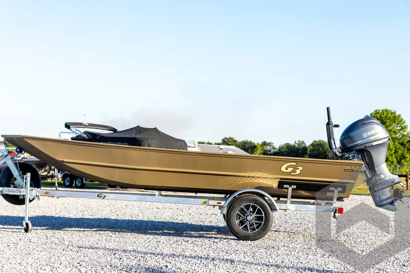 Slide: The Image of 2026 G3 1652 VBW boat on trailer with Yamaha outboard motor, parked on gravel. - 8