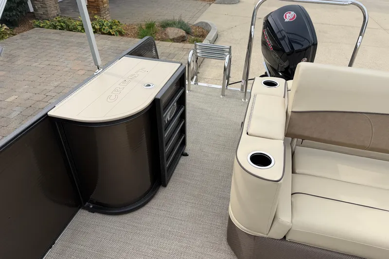 Slide: The Image of 2019 Crest II 240 SLS boat interior with beige seating and metal poles. - 11