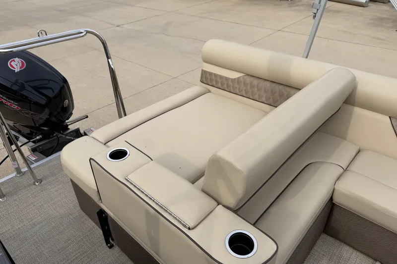 Slide: The Image of 2019 Crest II 240 SLS boat interior with beige seating and cup holders. - 12