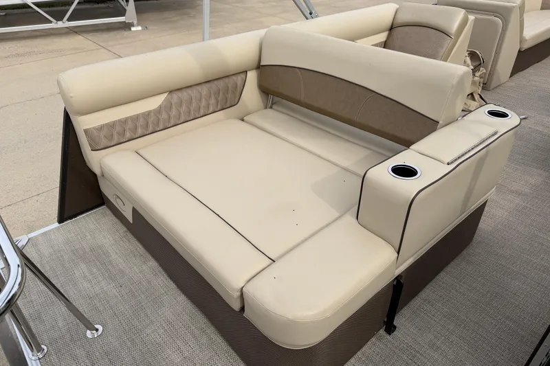 Slide: The Image of 2019 Crest II 240 SLS boat seating with beige upholstery and cup holders. - 15