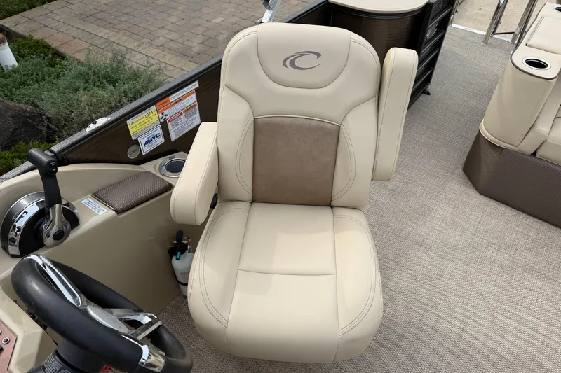 Slide: The Image of 2019 Crest II 240 SLS pontoon boat with beige seating and storage area. - 7