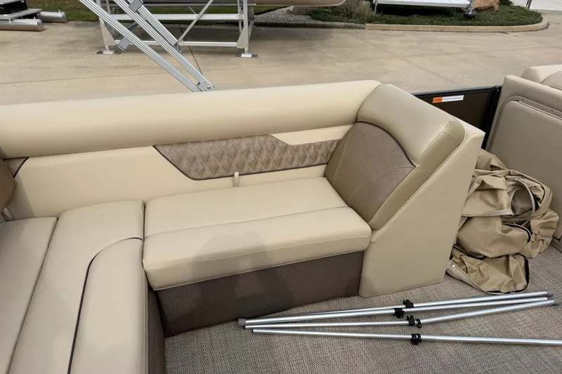 Slide: The Image of Captain's chair on 2019 Crest II 240 SLS pontoon boat, featuring beige upholstery and armrests. - 9