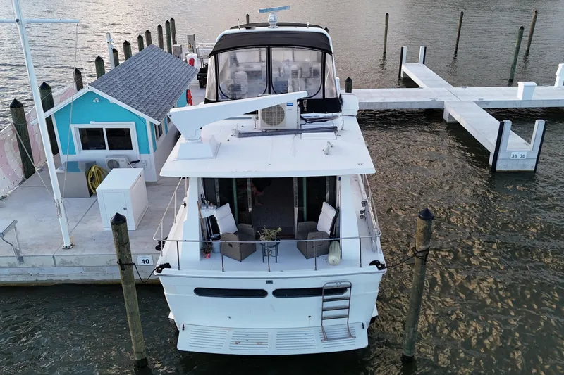 Slide: The Image of 1987 Viking Gulfstar yacht docked at marina with turquoise building nearby. - 10