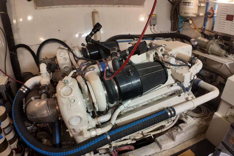Slide: The Image of Engine room of a 1987 Viking Gulfstar yacht, showcasing complex machinery and piping. - 12