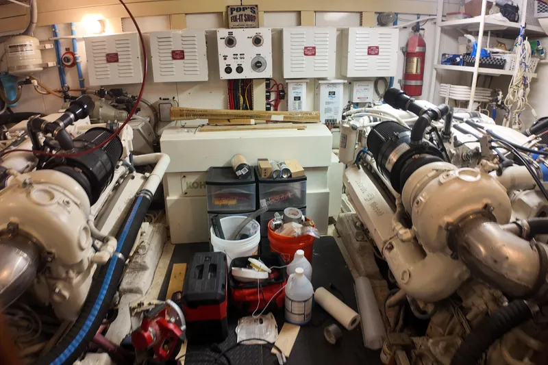 Slide: The Image of Engine room of a 1987 Viking Gulfstar boat with dual engines and maintenance tools. - 13